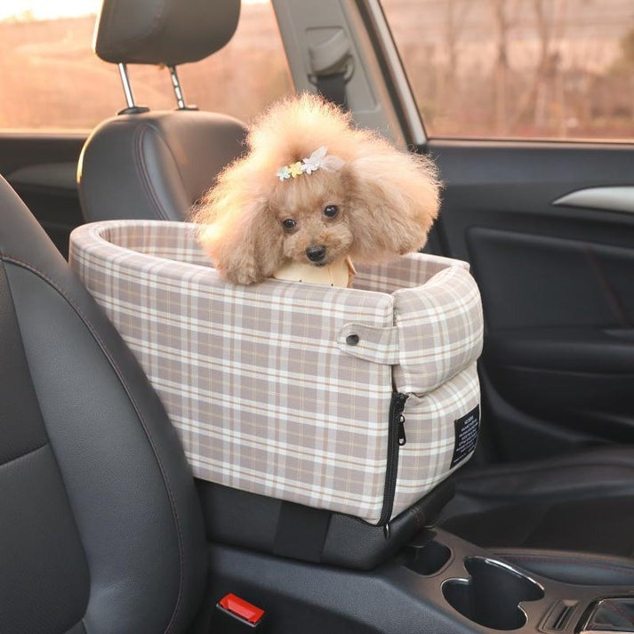 Dog in a plaid pet seat in a car